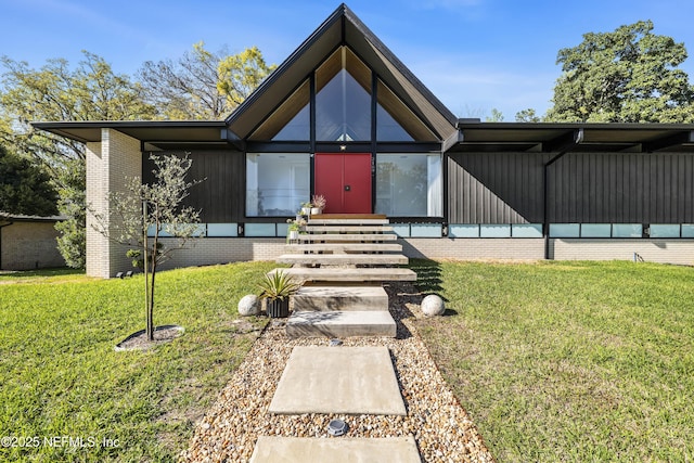 view of exterior entry with a lawn