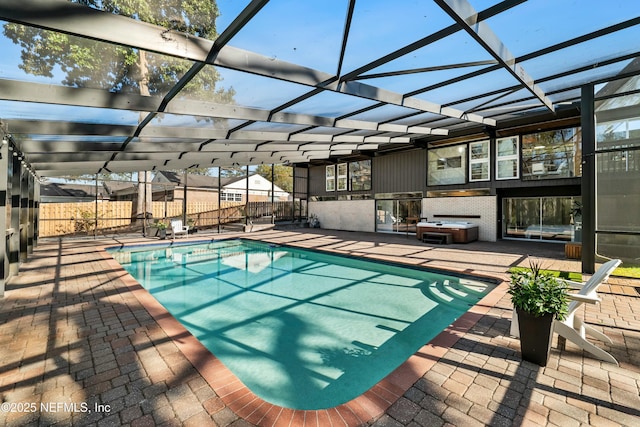 view of swimming pool featuring a lanai, fence, a patio area, and a fenced in pool