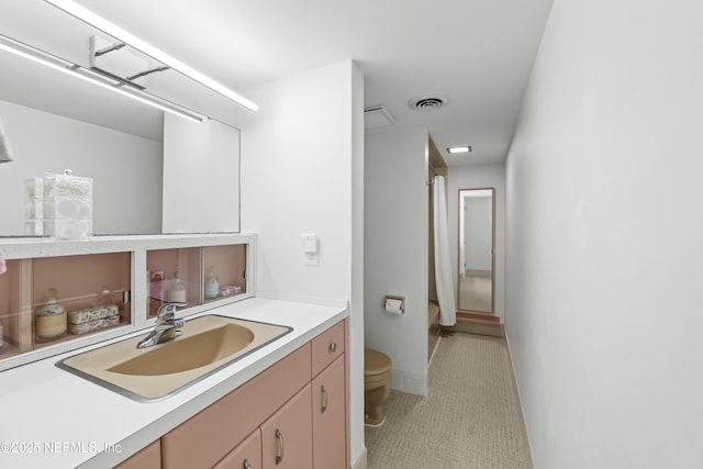 full bath featuring vanity, curtained shower, toilet, and visible vents