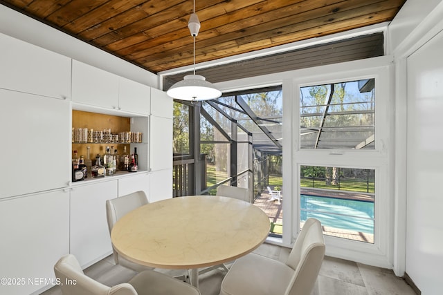 dining area with a wealth of natural light, wooden ceiling, and a sunroom