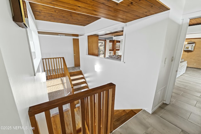 staircase with visible vents, wooden ceiling, and wood finished floors