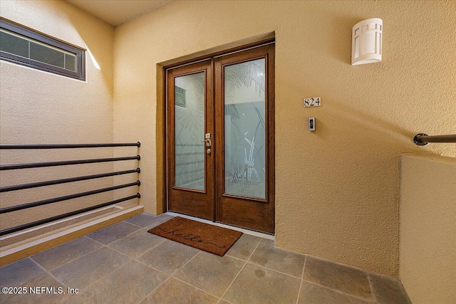 doorway to property featuring stucco siding and a balcony