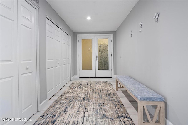 mudroom featuring french doors and baseboards