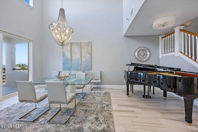 dining area featuring a wealth of natural light, stairway, a high ceiling, and an inviting chandelier