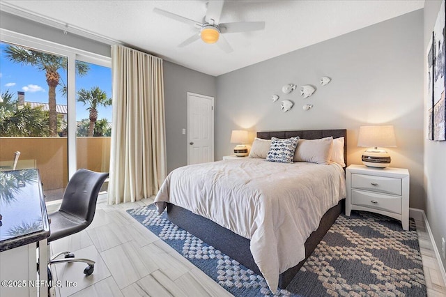 bedroom featuring baseboards, ceiling fan, and access to outside