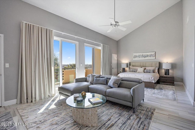 bedroom with baseboards, light wood finished floors, high vaulted ceiling, ceiling fan, and access to exterior