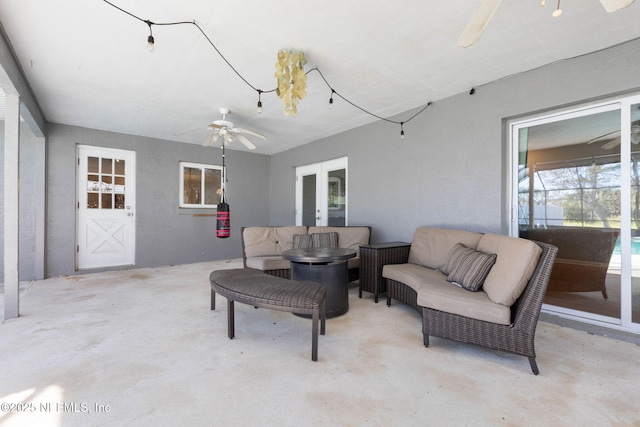 view of patio with an outdoor living space and a ceiling fan