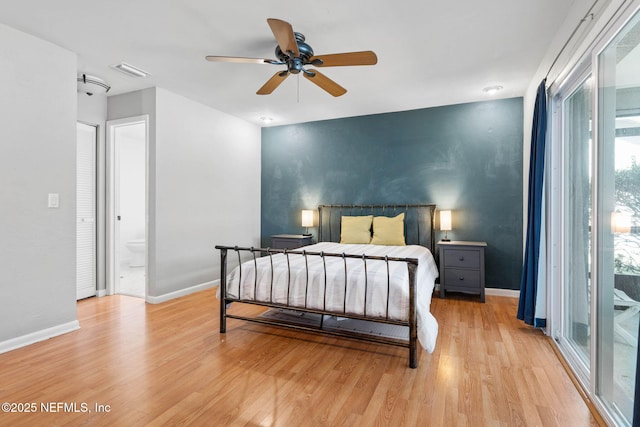 bedroom with visible vents, baseboards, ensuite bath, and light wood-style flooring