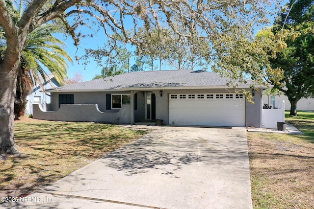 ranch-style home featuring a shingled roof, a front lawn, stucco siding, driveway, and an attached garage