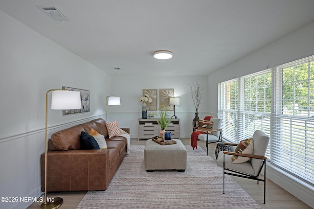 living room with wood finished floors and visible vents