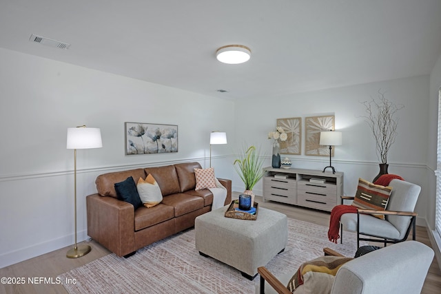 living area with visible vents and light wood-style flooring