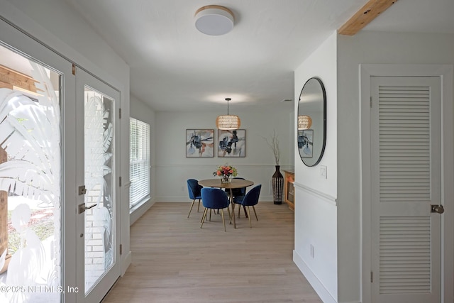 dining area with baseboards and light wood-type flooring