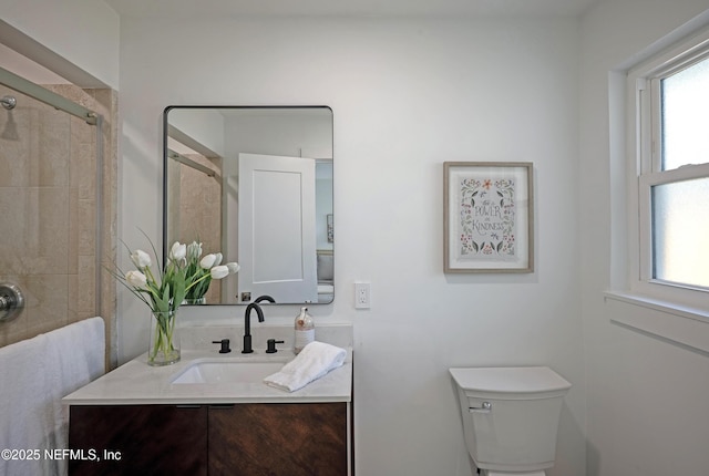 full bath with tiled shower, toilet, and vanity