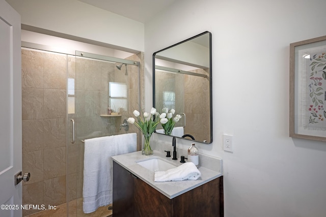 full bath featuring vanity and a shower stall