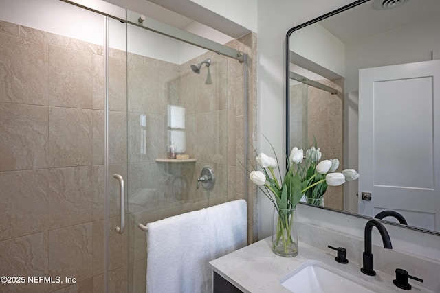 bathroom featuring vanity and a stall shower