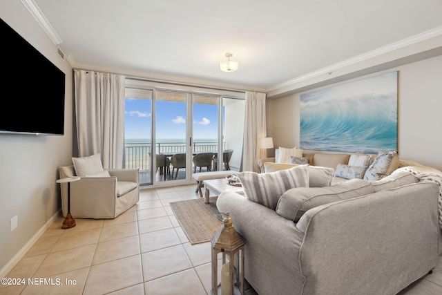 living room with visible vents, baseboards, a water view, ornamental molding, and light tile patterned floors