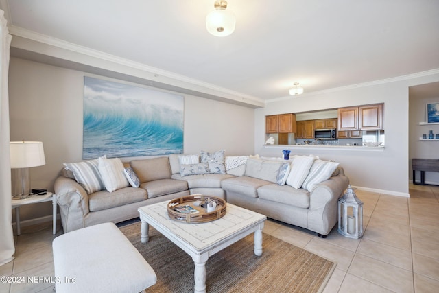 living room featuring light tile patterned floors, crown molding, and baseboards