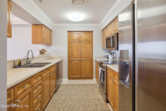 kitchen featuring light tile patterned floors, ornamental molding, a sink, light countertops, and appliances with stainless steel finishes