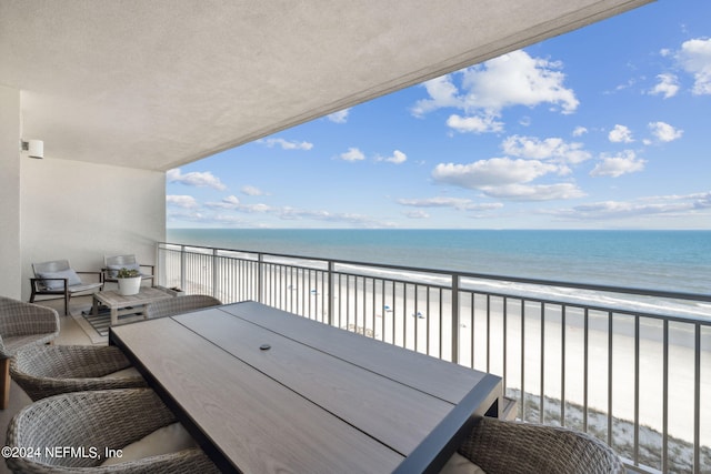 balcony with a view of the beach and a water view