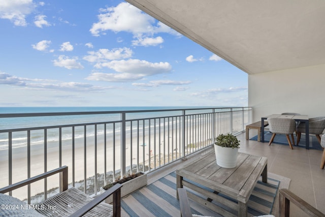 balcony with a beach view and a water view