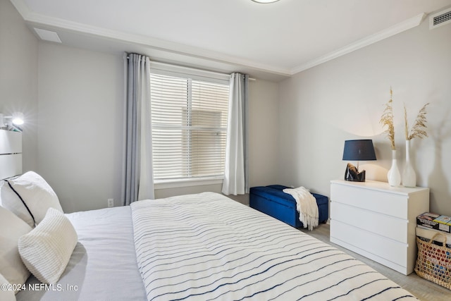 bedroom with visible vents and crown molding