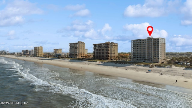 exterior space featuring a city view, a view of the beach, and a water view