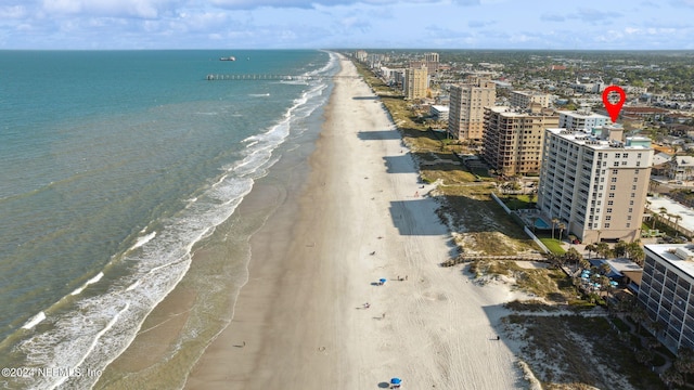 aerial view featuring a city view, a beach view, and a water view