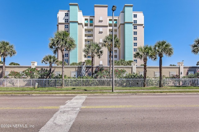 view of building exterior with fence