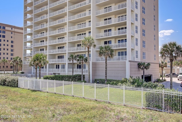 view of building exterior with fence