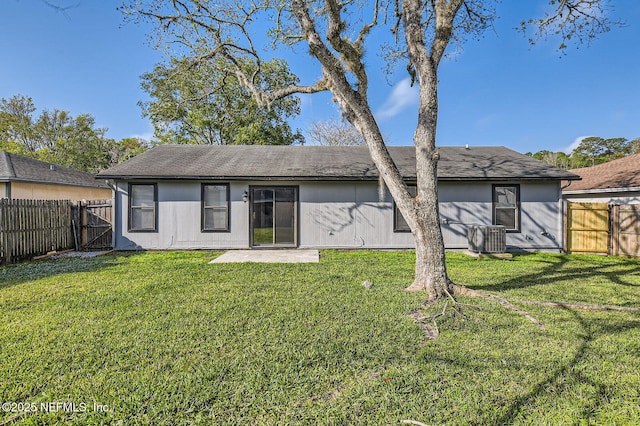 1602 Ibis Dr, Orange Park, FL 32065 - back of house with central air condition unit, a gate, a fenced backyard, a yard, and roof with shingles