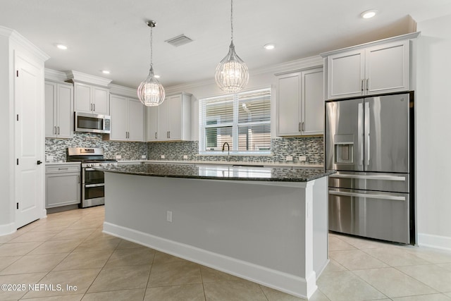 kitchen featuring light tile patterned floors, visible vents, dark stone countertops, and appliances with stainless steel finishes