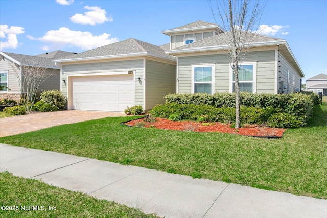 view of front facade featuring a garage, driveway, and a front lawn