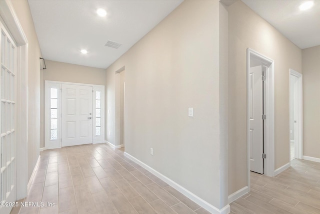 foyer entrance with recessed lighting, visible vents, baseboards, and wood tiled floor