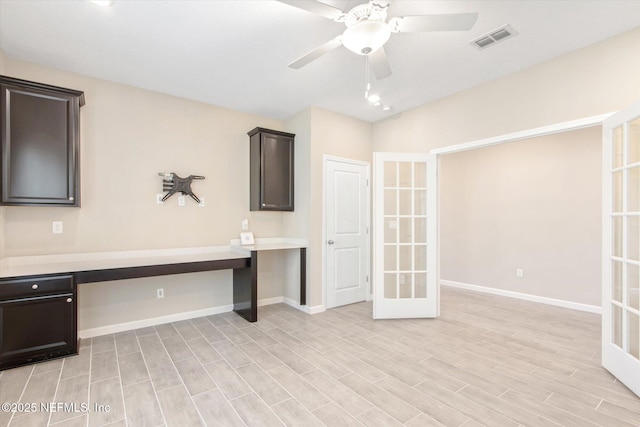 unfurnished office featuring visible vents, baseboards, light wood-style floors, and a ceiling fan