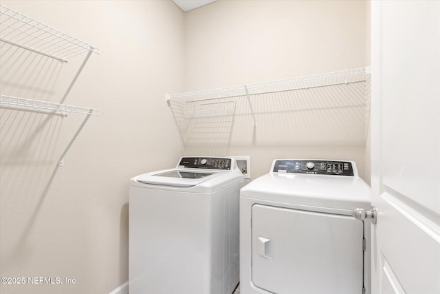 clothes washing area featuring laundry area and separate washer and dryer