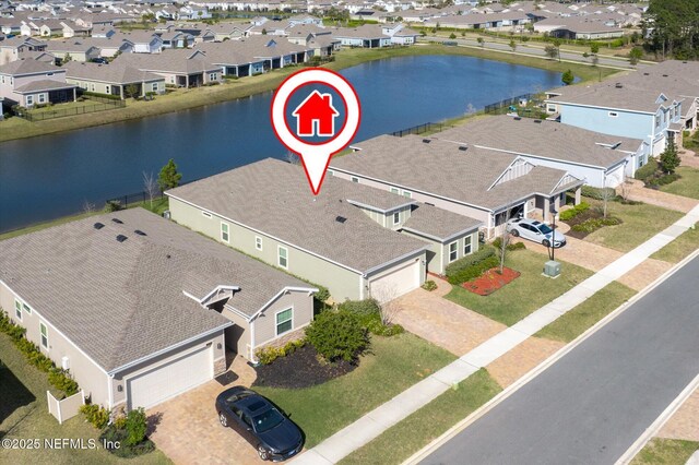 drone / aerial view featuring a residential view and a water view