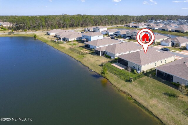 drone / aerial view featuring a residential view and a water view