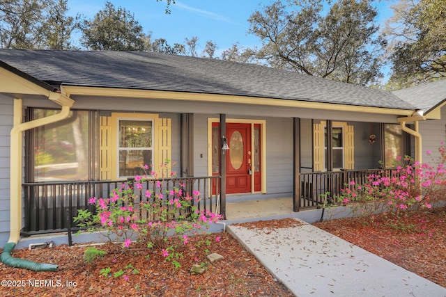 view of front of property with a porch and a shingled roof