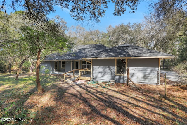 back of property featuring fence