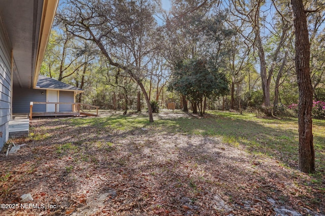 view of yard featuring a wooden deck