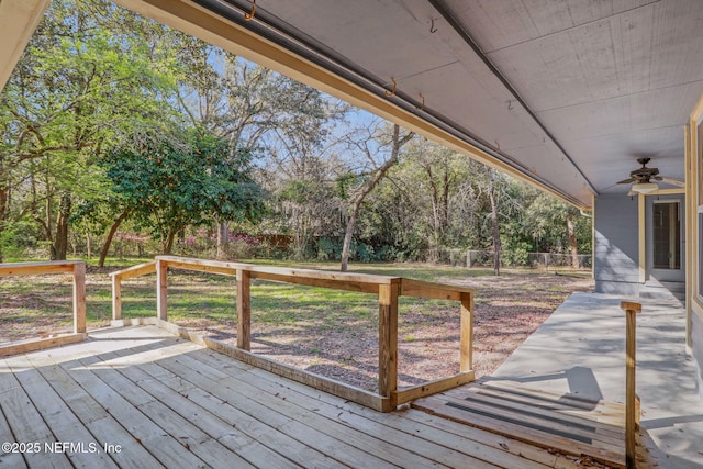 wooden terrace with a ceiling fan and a fenced backyard