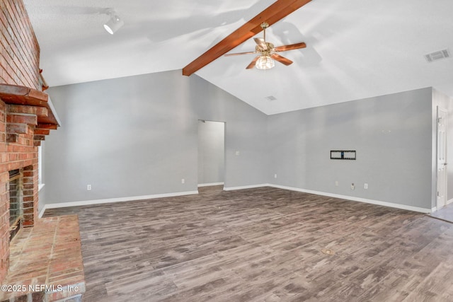 unfurnished living room featuring a brick fireplace, vaulted ceiling with beams, wood finished floors, and ceiling fan