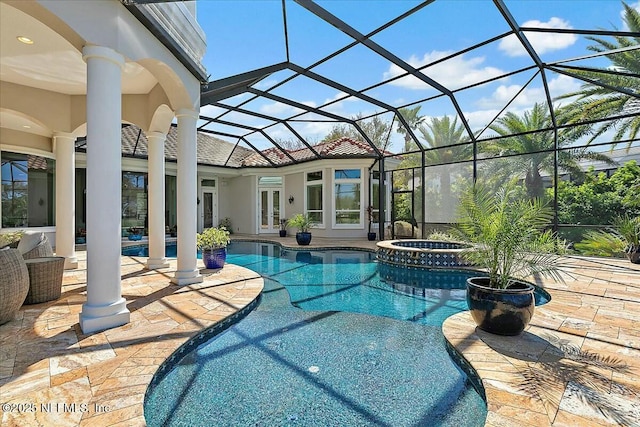 view of pool featuring a patio area, french doors, a pool with connected hot tub, and a lanai