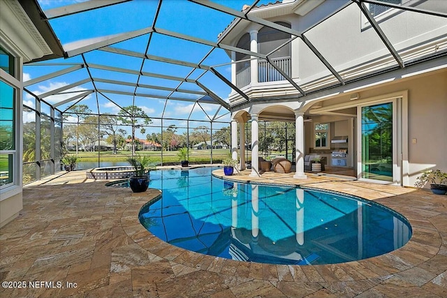 pool with glass enclosure, a patio, and a water view