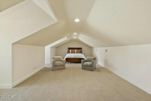 unfurnished bedroom with a textured ceiling, recessed lighting, carpet, baseboards, and vaulted ceiling