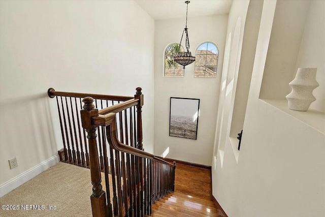 stairs featuring baseboards and wood finished floors