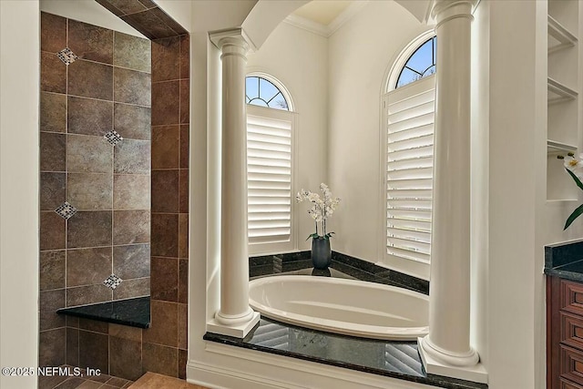 full bath with a garden tub, a tile shower, and ornate columns