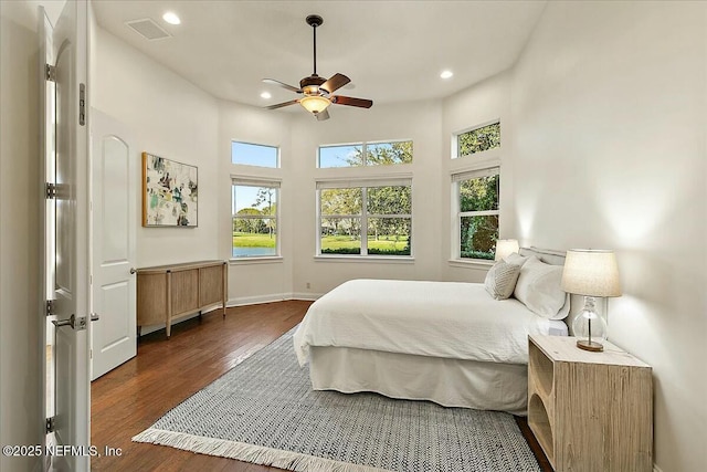 bedroom with recessed lighting, wood finished floors, visible vents, and baseboards