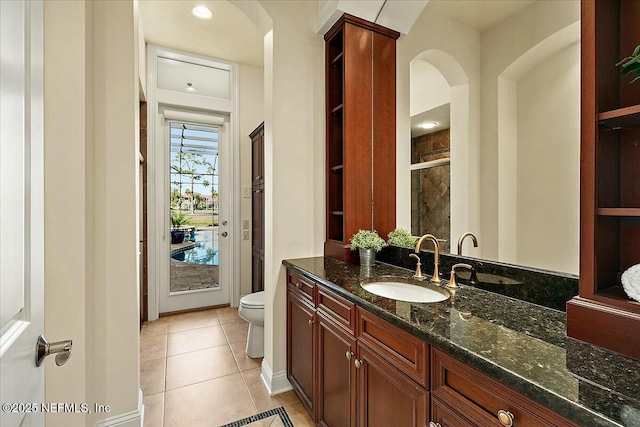 full bathroom featuring tile patterned floors, toilet, a stall shower, and vanity