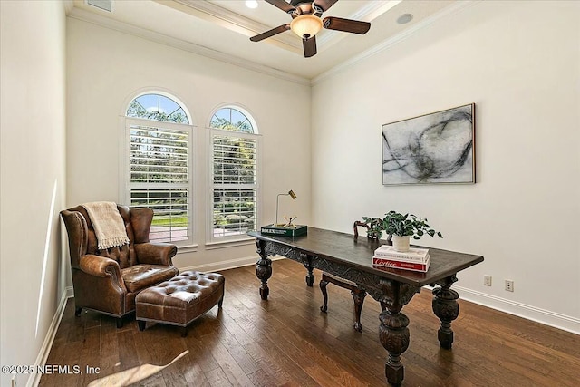 home office featuring a raised ceiling, hardwood / wood-style floors, crown molding, baseboards, and ceiling fan